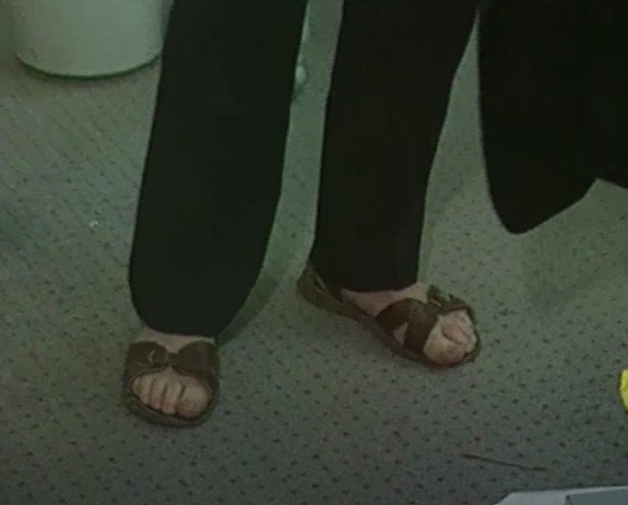 A pair of feet wearing sandals AI-generated content may be incorrect.